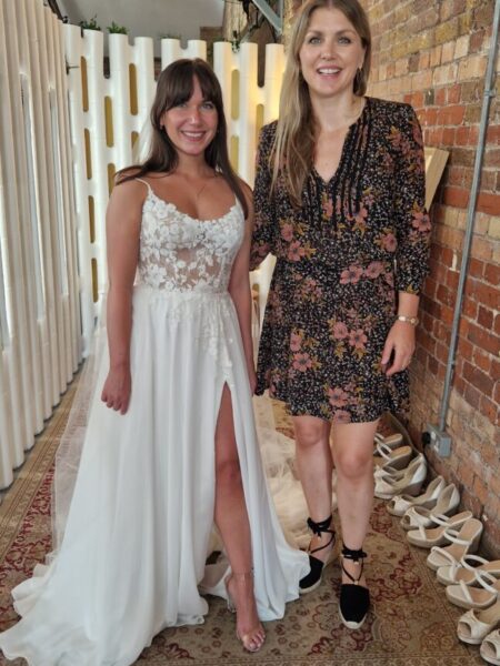 Sabrina from Love is Blind UK wearing her wedding dress with Caroline Black from Evelie in the changing room. 